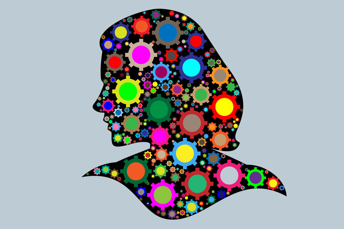Silhouette of a female's head filled with multi-colored gears
